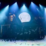 The Soot Sprites creating a path across the stage and in front of the house.